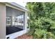 Covered screened porch with views of the neighborhood, adjacent to lush greenery at 4772 Silver Cir, Zephyrhills, FL 33541