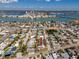 Aerial view of the property highlighted with a red arrow, neighborhood and beautiful waterway views at 479 80Th Way, St Pete Beach, FL 33706