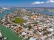 Aerial view of home, waterways, tennis courts, school, businesses, and neighborhood surrounding the property at 479 80Th Way, St Pete Beach, FL 33706