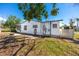 Backyard view of the home showing the house, yard, and partial fence at 479 80Th Way, St Pete Beach, FL 33706