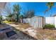 Backyard with a storage shed, small wood bench, and a partial fence at 479 80Th Way, St Pete Beach, FL 33706