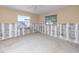 Bedroom with two windows and ceiling fan awaiting renovations at 479 80Th Way, St Pete Beach, FL 33706