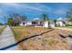 Residential home with an attached garage, a vibrant red front door, and a well kept lawn at 479 80Th Way, St Pete Beach, FL 33706