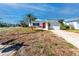 Cute single-story home with a bright red door and well-lit street, ready for a new owner at 479 80Th Way, St Pete Beach, FL 33706