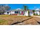 Traditional single-Gathering home with a well-manicured lawn, white exterior, and a cozy front porch at 479 80Th Way, St Pete Beach, FL 33706