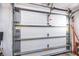 View of a white paneled garage door showing the hardware and opening mechanism at 479 80Th Way, St Pete Beach, FL 33706