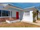 Charming single-story home with a red front door, offering a welcoming entrance and cozy curb appeal at 479 80Th Way, St Pete Beach, FL 33706