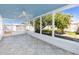 Screened-in porch featuring a ceiling fan, tiled floor, and serene backyard views at 479 80Th Way, St Pete Beach, FL 33706