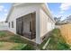 Exterior view of a home featuring a screened-in patio and partial yard with a wood fence at 4907 15Th N Ave, St Petersburg, FL 33710