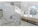 Stunning bathroom featuring marble shower, modern double vanity, and stylish round mirrors at 4907 15Th N Ave, St Petersburg, FL 33710