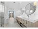 Elegant bathroom boasting double sinks, marble countertops, and contemporary lighting fixtures at 4907 15Th N Ave, St Petersburg, FL 33710