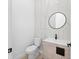 Modern powder room features designer wallpaper, stylish sink, and round mirror at 4907 15Th N Ave, St Petersburg, FL 33710