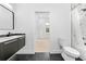 Bright bathroom features black hexagon tiles, a shower with geometric tile, and a modern commode at 4907 15Th N Ave, St Petersburg, FL 33710