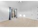 Minimalist bedroom with light wood floors, white walls, and a sliding glass door at 4907 15Th N Ave, St Petersburg, FL 33710