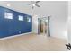 Bright bedroom with blue accent wall, light floors, and sliding glass door to backyard at 4907 15Th N Ave, St Petersburg, FL 33710