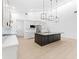 Open-concept kitchen with an island, stainless steel appliances, and modern lighting fixtures at 4907 15Th N Ave, St Petersburg, FL 33710