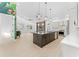 Bright, open kitchen with stainless steel appliances, island with dark cabinets, and adjacent living area at 4907 15Th N Ave, St Petersburg, FL 33710