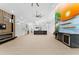 Open living room with fireplace, mural, ceiling fan and kitchen in the background at 4907 15Th N Ave, St Petersburg, FL 33710