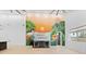 Living room with a tropical mural, floating shelves, bar and lots of light at 4907 15Th N Ave, St Petersburg, FL 33710