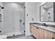 Modern bathroom featuring a glass walk-in shower, wood vanity and black hardware at 5017 W Dickens Ave, Tampa, FL 33629
