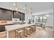 Modern kitchen featuring sleek cabinetry, a large marble island with seating, pendant lighting, and stainless steel appliances at 5017 W Dickens Ave, Tampa, FL 33629