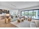 Expansive living room open to the kitchen, featuring modern furnishings, large windows, and seamless indoor-outdoor flow at 5017 W Dickens Ave, Tampa, FL 33629