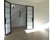 Open living space with light hardwood floors, bi-fold doors and a contemporary staircase at 5017 W Dickens Ave, Tampa, FL 33629