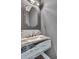 Stylish powder room featuring a unique marble countertop, vessel sink, and decorative mirror and lighting at 5017 W Dickens Ave, Tampa, FL 33629