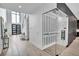 Stunning wine cellar adjacent to the main entryway, featuring glass enclosure, metal wine racks, and ambient lighting at 5017 W Dickens Ave, Tampa, FL 33629