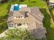 Expansive house with a manicured lawn, in-ground pool with waterslide, and a sprawling tile roof at 5546 Drexel Rd, Land O Lakes, FL 34638