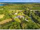 Expansive property featuring a pool, detached garage and lush green surroundings at 5546 Drexel Rd, Land O Lakes, FL 34638