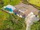 Aerial view of an expansive home with a pool, manicured landscaping, and a large driveway at 5546 Drexel Rd, Land O Lakes, FL 34638