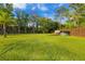 A large grassy backyard is fully fenced for privacy, offering ample space for recreation and outdoor activities at 5546 Drexel Rd, Land O Lakes, FL 34638
