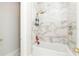 Bright bathroom features marble tile, bronze fixtures and a built-in tub at 5546 Drexel Rd, Land O Lakes, FL 34638