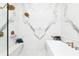 This shower room has double shower heads with white marble walls and floors and a long marble bench at 5546 Drexel Rd, Land O Lakes, FL 34638
