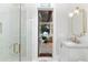 Elegant bathroom with marble vanity, gold fixtures, and a glass-enclosed shower at 5546 Drexel Rd, Land O Lakes, FL 34638