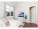 This bedroom features hardwood floors, a large window, and a flat screen television on a dresser at 5546 Drexel Rd, Land O Lakes, FL 34638
