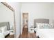 This bedroom has hardwood floors, a large framed mirror, and a flat screen television at 5546 Drexel Rd, Land O Lakes, FL 34638