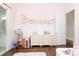 Bright and stylish bedroom featuring wood floors, neutral colors, and fun decor at 5546 Drexel Rd, Land O Lakes, FL 34638