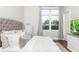 This bedroom has hardwood floors, a large window, and a flat screen television on a dresser at 5546 Drexel Rd, Land O Lakes, FL 34638