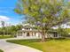 Striking single-story home with modern design, spacious driveway, and mature landscaping at 5546 Drexel Rd, Land O Lakes, FL 34638
