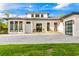 Beautiful modern home with a white exterior, dark trim, a welcoming entrance, and an expansive driveway at 5546 Drexel Rd, Land O Lakes, FL 34638