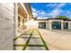 Stylish home showcasing clean lines, a three-car garage, concrete pathway with grass, and a welcoming front porch at 5546 Drexel Rd, Land O Lakes, FL 34638