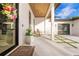 Welcoming front porch features rocking chairs, a tiled walkway, and a modern door with wreath at 5546 Drexel Rd, Land O Lakes, FL 34638