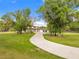A long driveway leads to this stunning home surrounded by lush greenery and mature trees at 5546 Drexel Rd, Land O Lakes, FL 34638