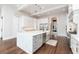 Elegant kitchen boasting a large island, pendant lighting, and modern white cabinetry at 5546 Drexel Rd, Land O Lakes, FL 34638