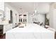 Open-concept kitchen featuring a marble island, pendant lights, and seamless flow to the living area at 5546 Drexel Rd, Land O Lakes, FL 34638