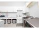 Bright laundry room featuring white cabinetry, gold hardware, and stylish patterned flooring at 5546 Drexel Rd, Land O Lakes, FL 34638