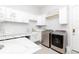 Beautiful laundry room with modern appliances, marble countertops, and ample storage space at 5546 Drexel Rd, Land O Lakes, FL 34638