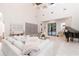 Open living space with herringbone floors, high ceiling, modern furniture, and a decorative piano at 5546 Drexel Rd, Land O Lakes, FL 34638